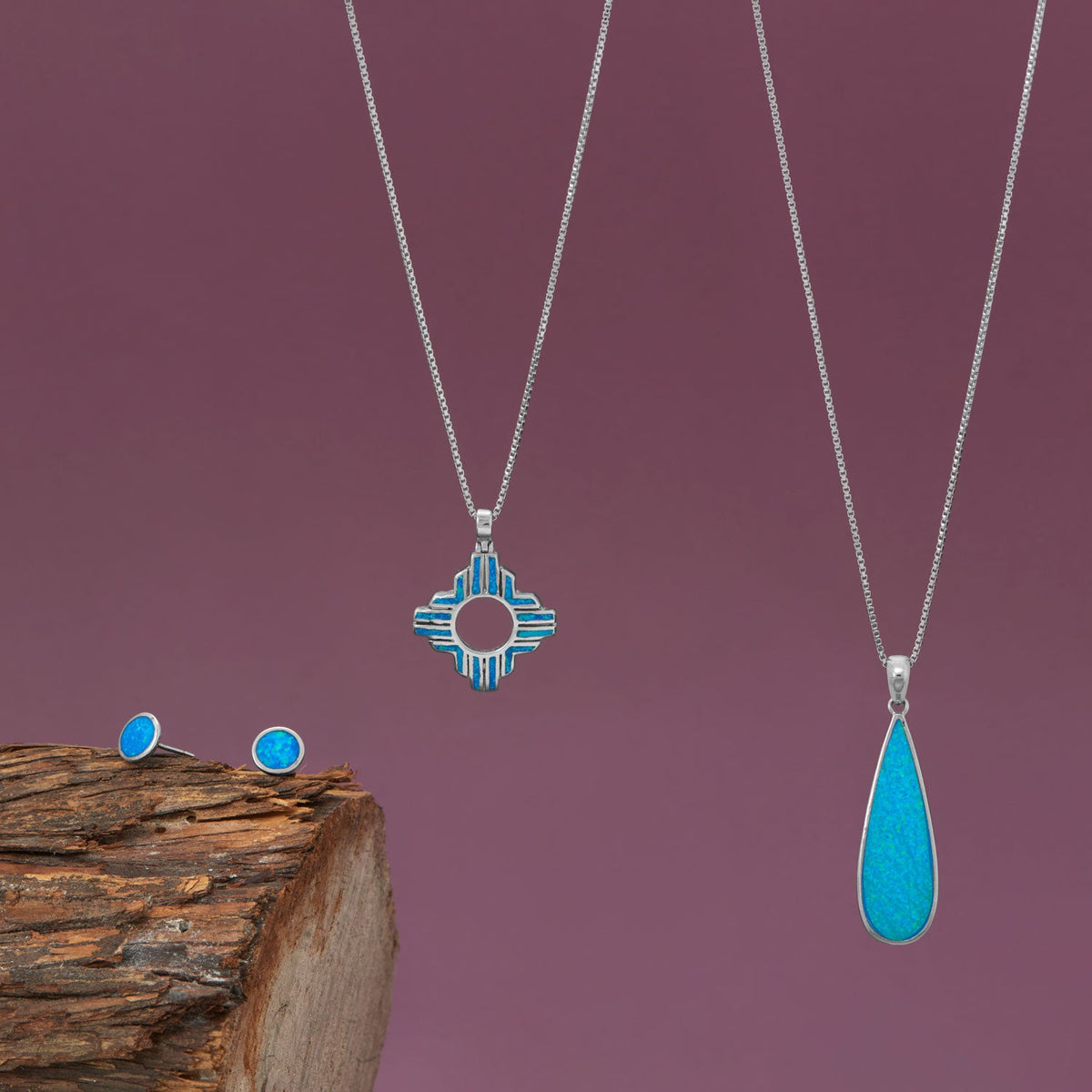 Rhodium Plated Synthetic Blue Opal Elongated Pear Pendant